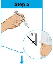 A close-up of a hand holding a syringe

Description automatically generated